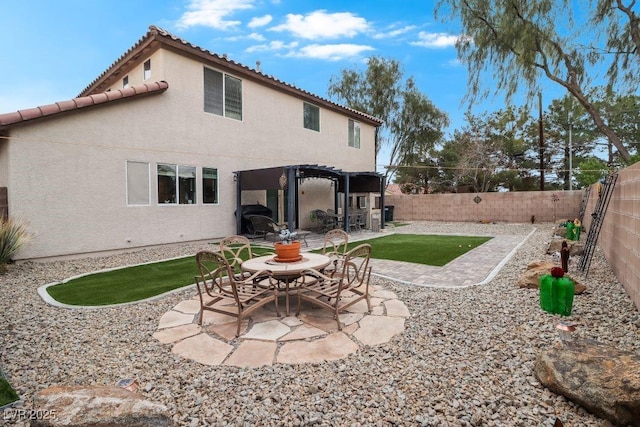 back of property with a patio, a fenced backyard, a pergola, and stucco siding