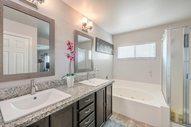 full bathroom featuring a sink, a jetted tub, and a shower stall