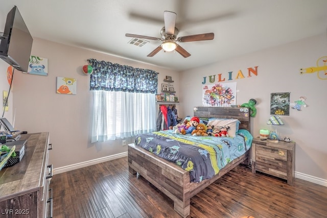 bedroom with visible vents, baseboards, wood finished floors, and a ceiling fan