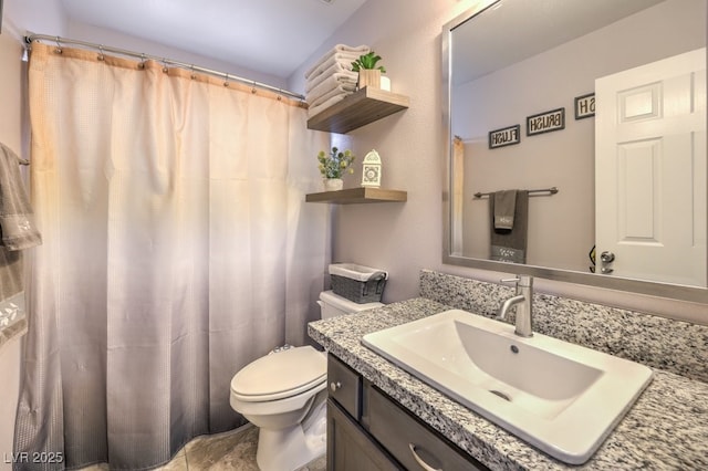 bathroom featuring a shower with shower curtain, toilet, and vanity