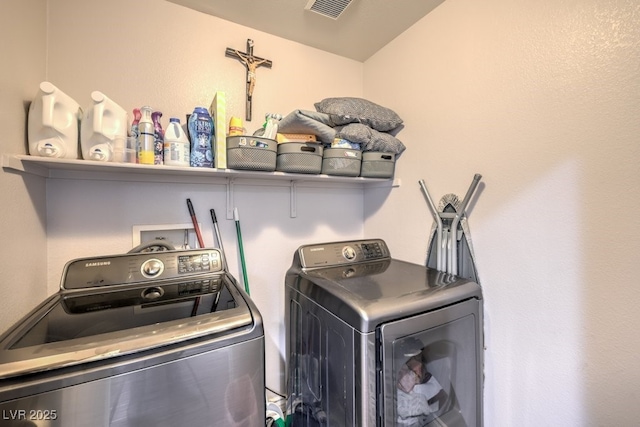 clothes washing area featuring washer and dryer, laundry area, and visible vents