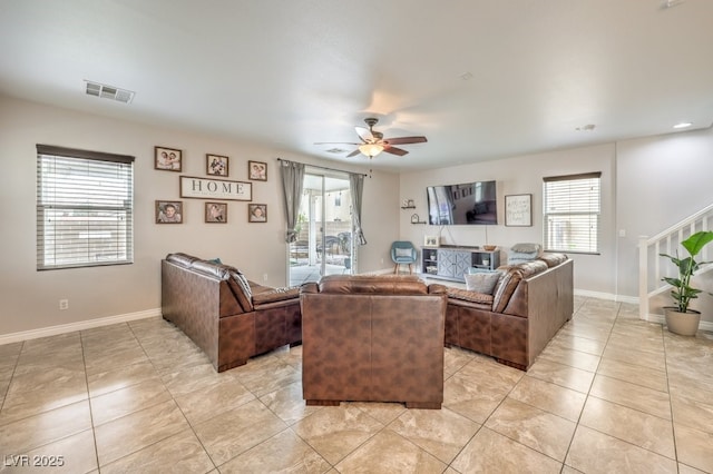 living room featuring visible vents, plenty of natural light, light tile patterned flooring, and a ceiling fan