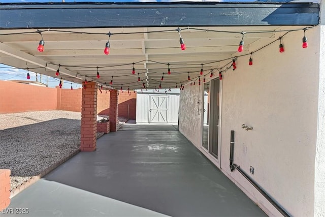 view of patio with an outbuilding and a fenced backyard