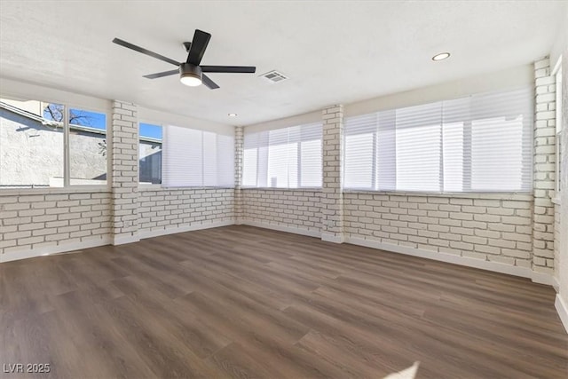 unfurnished sunroom featuring a ceiling fan and visible vents