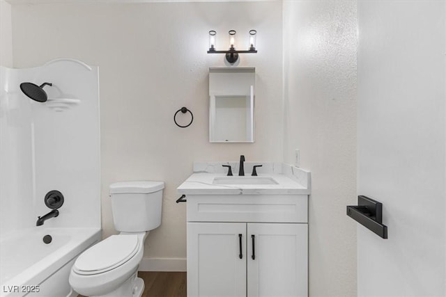 full bath featuring toilet, wood finished floors, shower / bathing tub combination, baseboards, and vanity