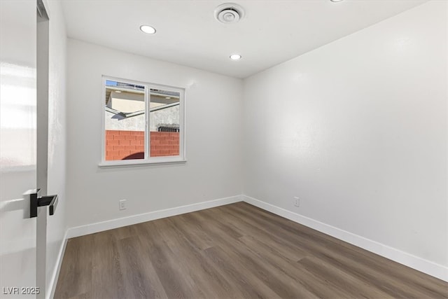 unfurnished room featuring dark wood finished floors, visible vents, recessed lighting, and baseboards