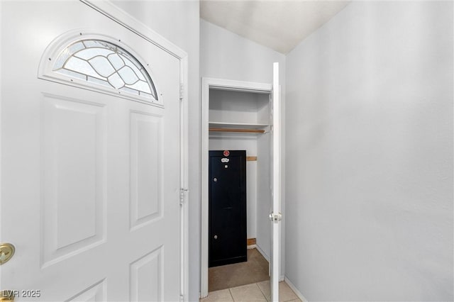 interior space with light tile patterned floors and baseboards