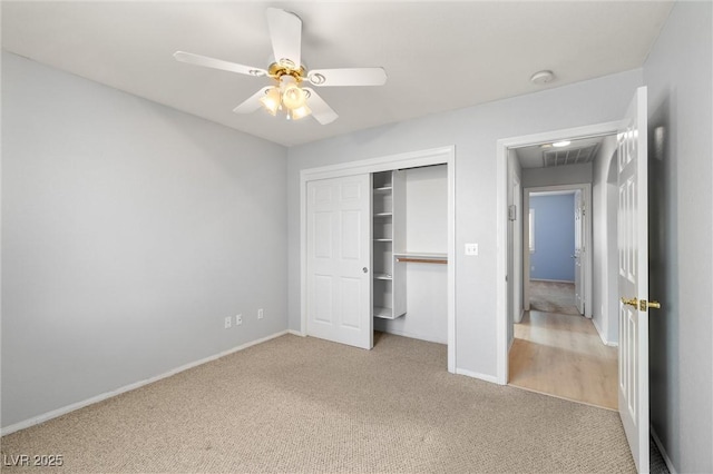 unfurnished bedroom with a closet, visible vents, baseboards, and carpet floors