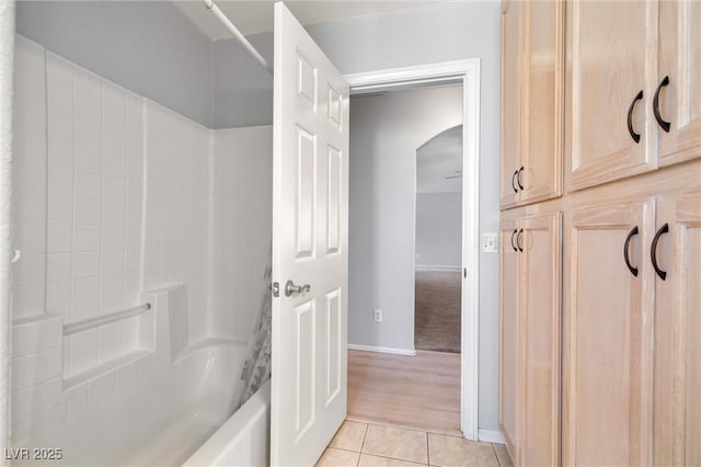 full bathroom with tile patterned flooring, bathtub / shower combination, and baseboards