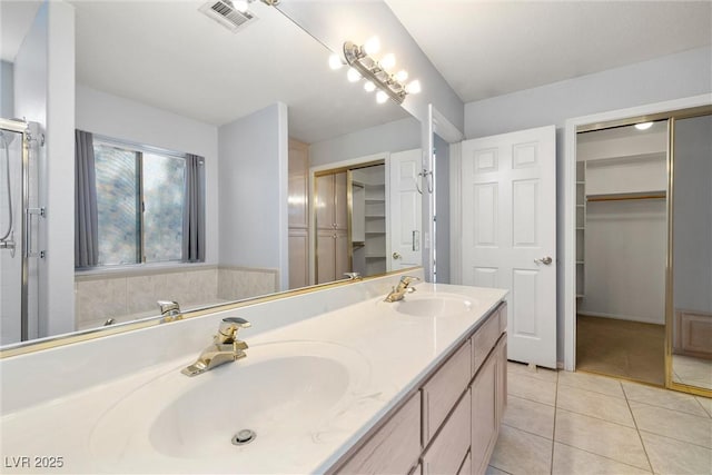 full bathroom with tile patterned flooring, visible vents, double vanity, and a sink