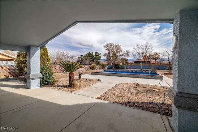 exterior space featuring a fenced in pool, a patio, and fence