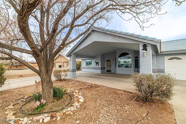 view of front of home with stucco siding and a tile roof