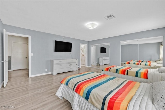 bedroom featuring baseboards and wood finished floors