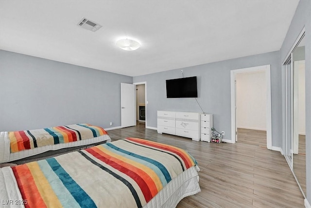 bedroom featuring wood finished floors and baseboards