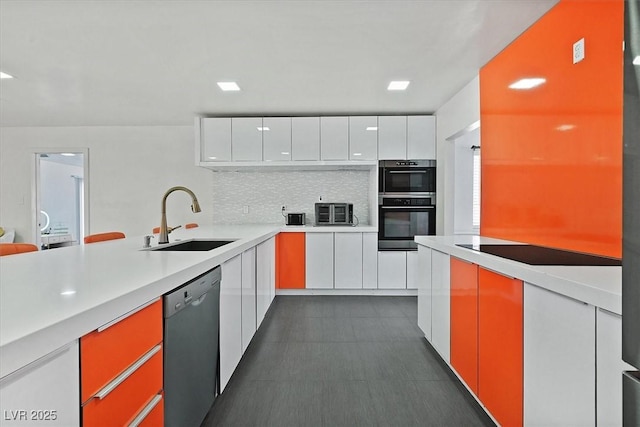 kitchen featuring a sink, black appliances, decorative backsplash, modern cabinets, and white cabinets