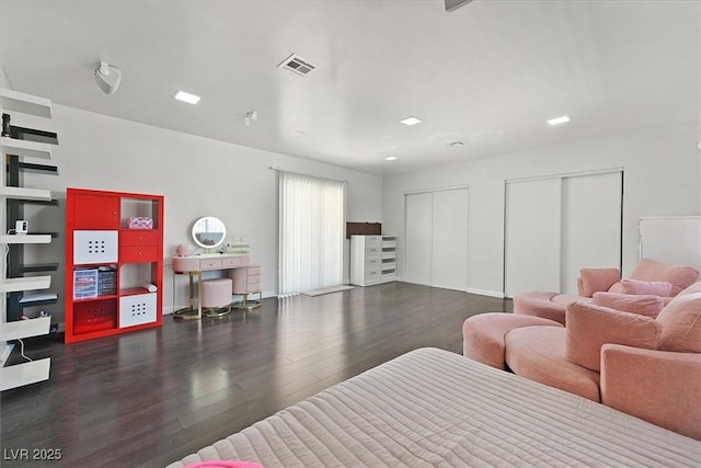 bedroom featuring two closets and wood finished floors