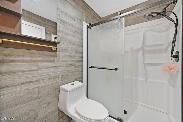 bathroom featuring a shower stall and toilet