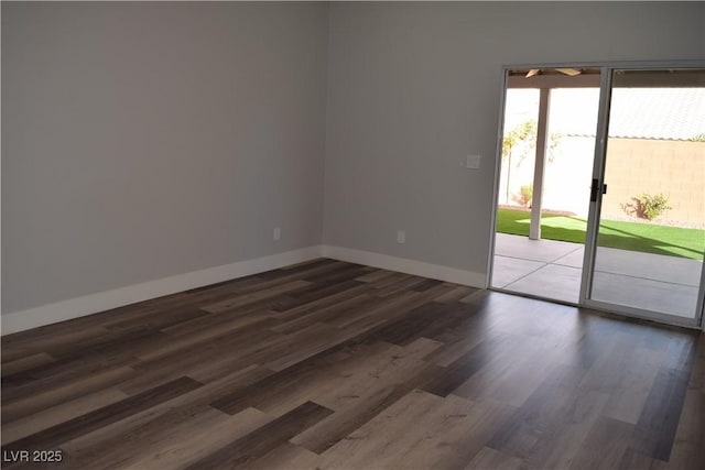 empty room featuring wood finished floors and baseboards