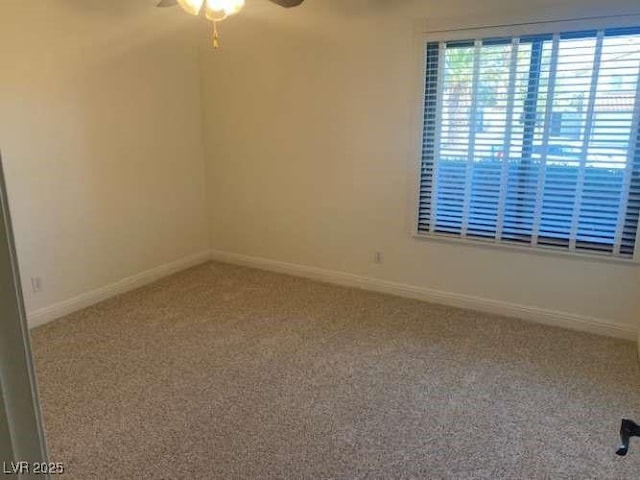 empty room with ceiling fan, baseboards, and carpet floors