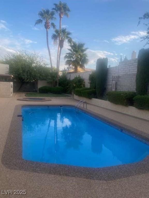 view of pool featuring a fenced in pool and fence