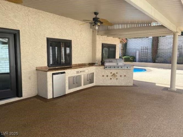 view of patio featuring area for grilling, a grill, and a ceiling fan