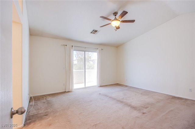 carpeted spare room featuring visible vents, baseboards, ceiling fan, and vaulted ceiling