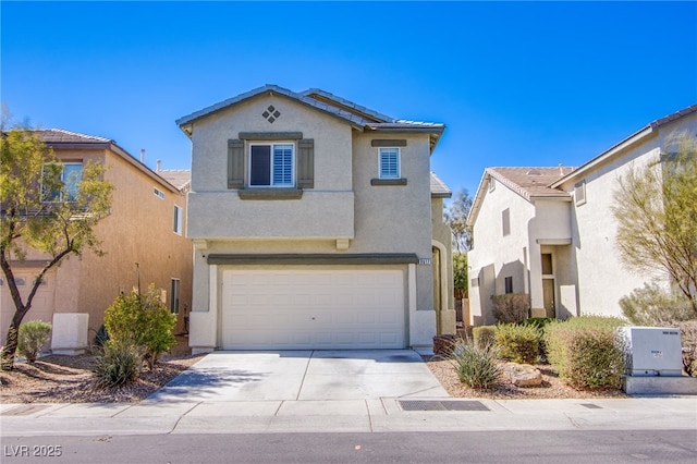 view of front of property with stucco siding, a garage, and driveway