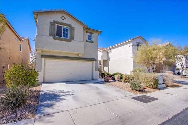 mediterranean / spanish-style house with stucco siding, driveway, and an attached garage