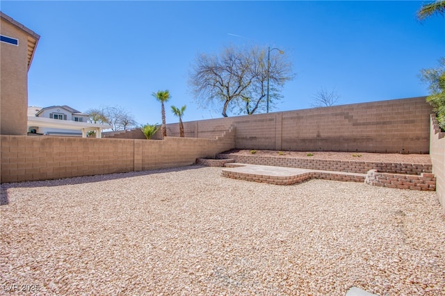 view of yard with a fenced backyard and a patio area