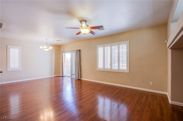 unfurnished living room featuring dark wood finished floors, ceiling fan with notable chandelier, baseboards, and visible vents