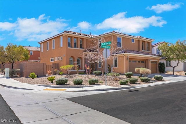 view of front of house featuring a tiled roof, stucco siding, a garage, and fence