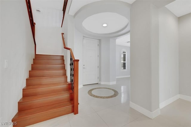 stairs with tile patterned floors and baseboards