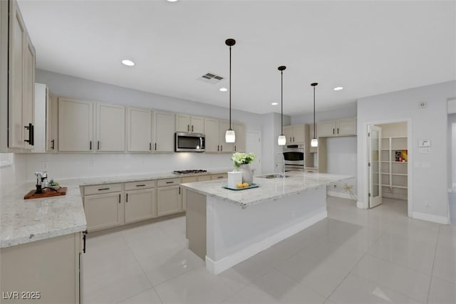 kitchen featuring visible vents, light stone countertops, recessed lighting, stainless steel appliances, and a sink