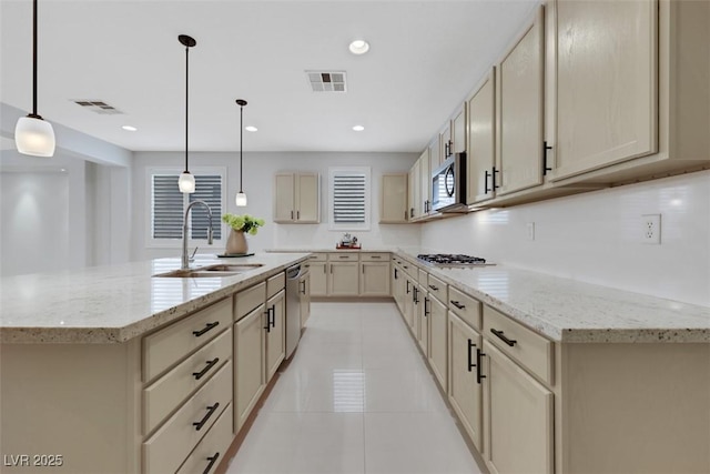 kitchen featuring a sink, visible vents, light tile patterned flooring, and stainless steel appliances