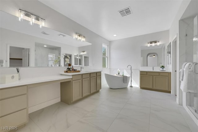 full bathroom featuring visible vents, a soaking tub, two vanities, a stall shower, and marble finish floor