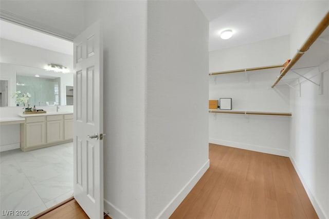 walk in closet featuring light wood-style flooring