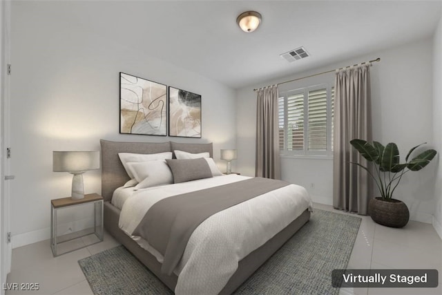 tiled bedroom with visible vents and baseboards