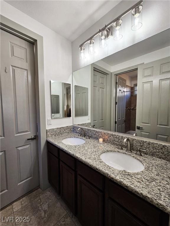 full bathroom with double vanity and a sink