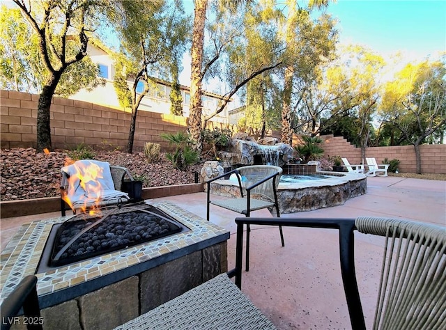 view of patio / terrace with a fire pit and a fenced backyard