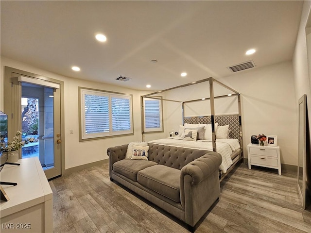 bedroom with access to outside, wood finished floors, and visible vents