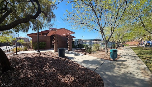 surrounding community with fence and a pergola