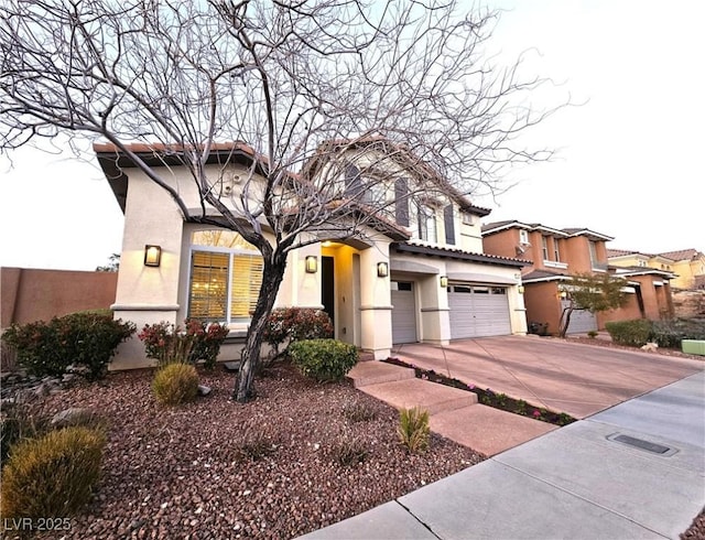 view of front of home featuring stucco siding, a garage, concrete driveway, and a tiled roof