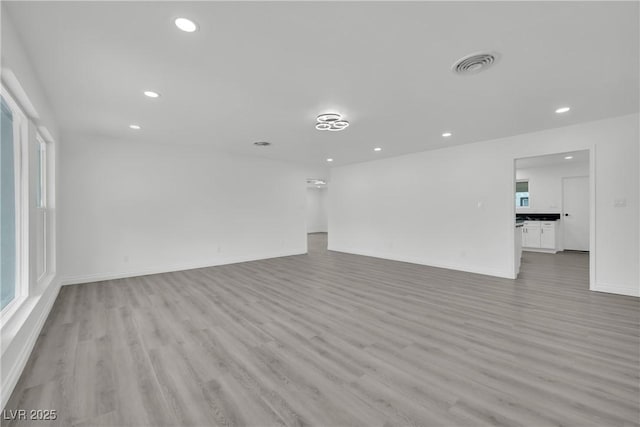 spare room featuring recessed lighting, light wood-style floors, and visible vents