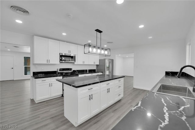 kitchen with visible vents, recessed lighting, light wood-style floors, appliances with stainless steel finishes, and white cabinets