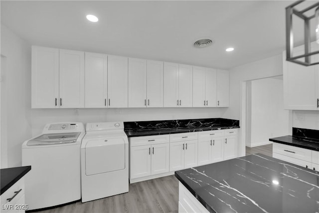 washroom with washing machine and clothes dryer, recessed lighting, visible vents, and light wood-type flooring