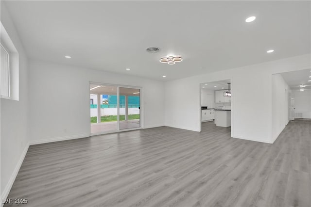 unfurnished living room with baseboards, recessed lighting, visible vents, and light wood-type flooring