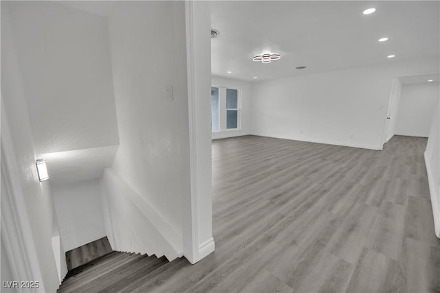 unfurnished room featuring recessed lighting, visible vents, baseboards, and wood finished floors