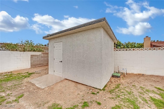 view of shed with a fenced backyard