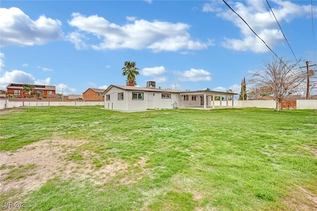 back of house featuring a patio area, a lawn, and a fenced backyard