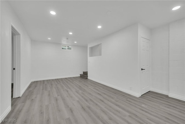 finished below grade area featuring recessed lighting, baseboards, and wood finished floors